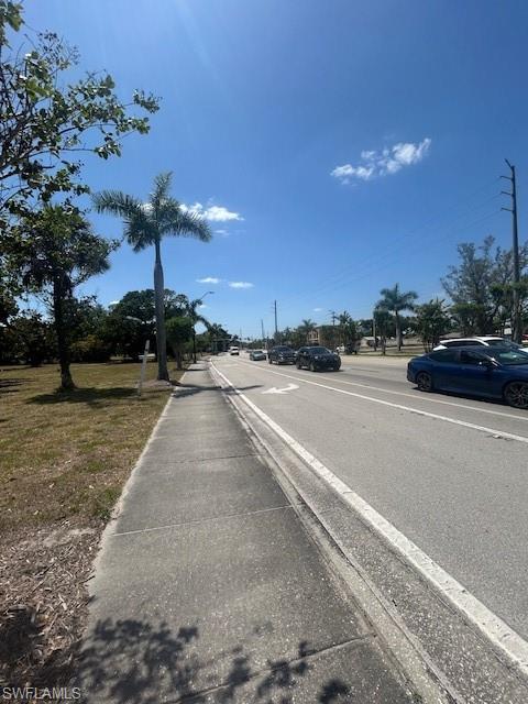 Image 3: View of street featuring curbs, sidewalks, and street lighting
