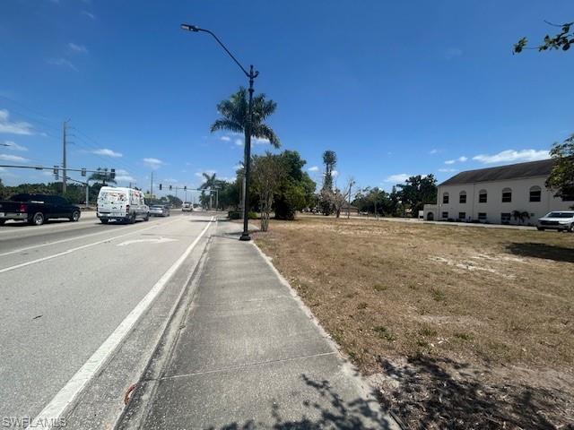 Image 4: View of street featuring sidewalks and street lights