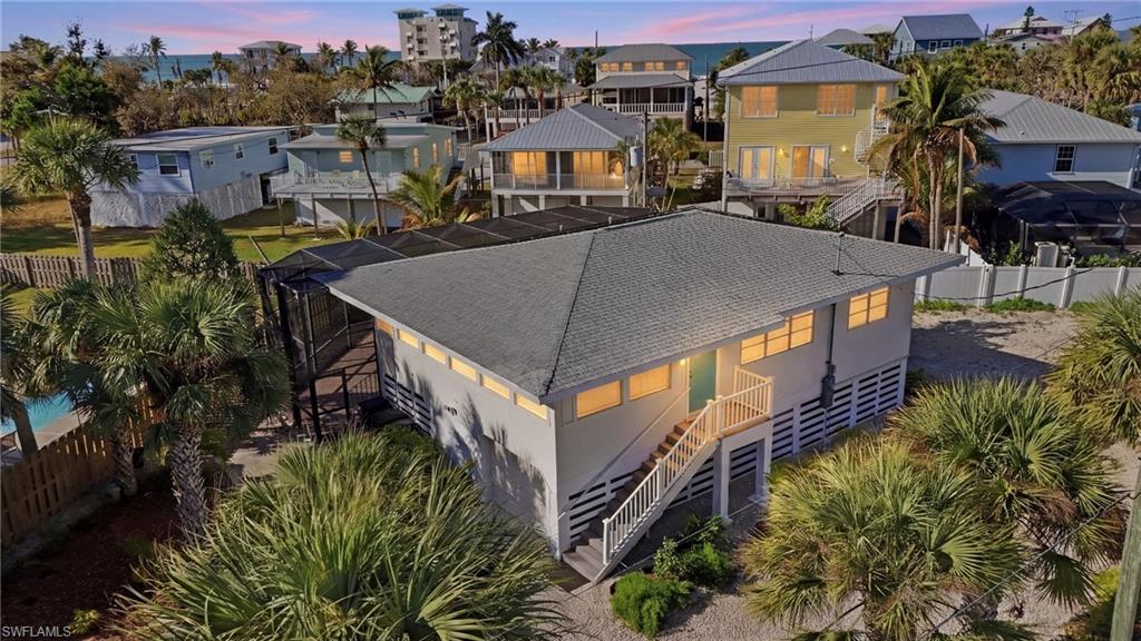 Image 3: Aerial view of elevated home just steps to Gulf waters and beach - Virtually Edited Image