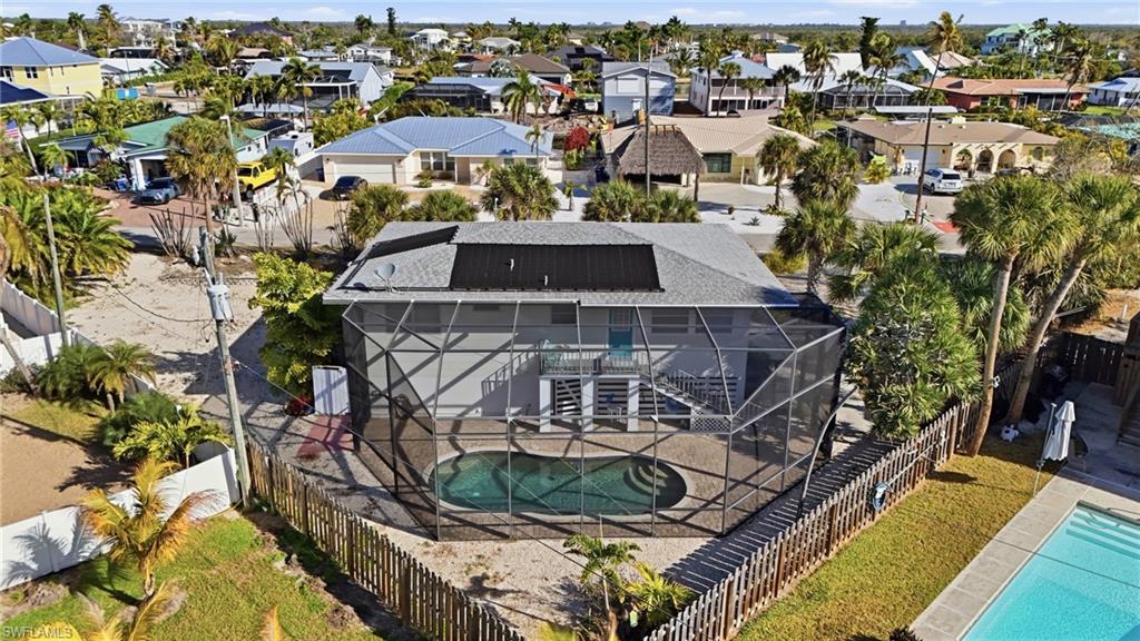 Image 4: Bird's eye view of a pool and rear of home - Virtually Edited Image