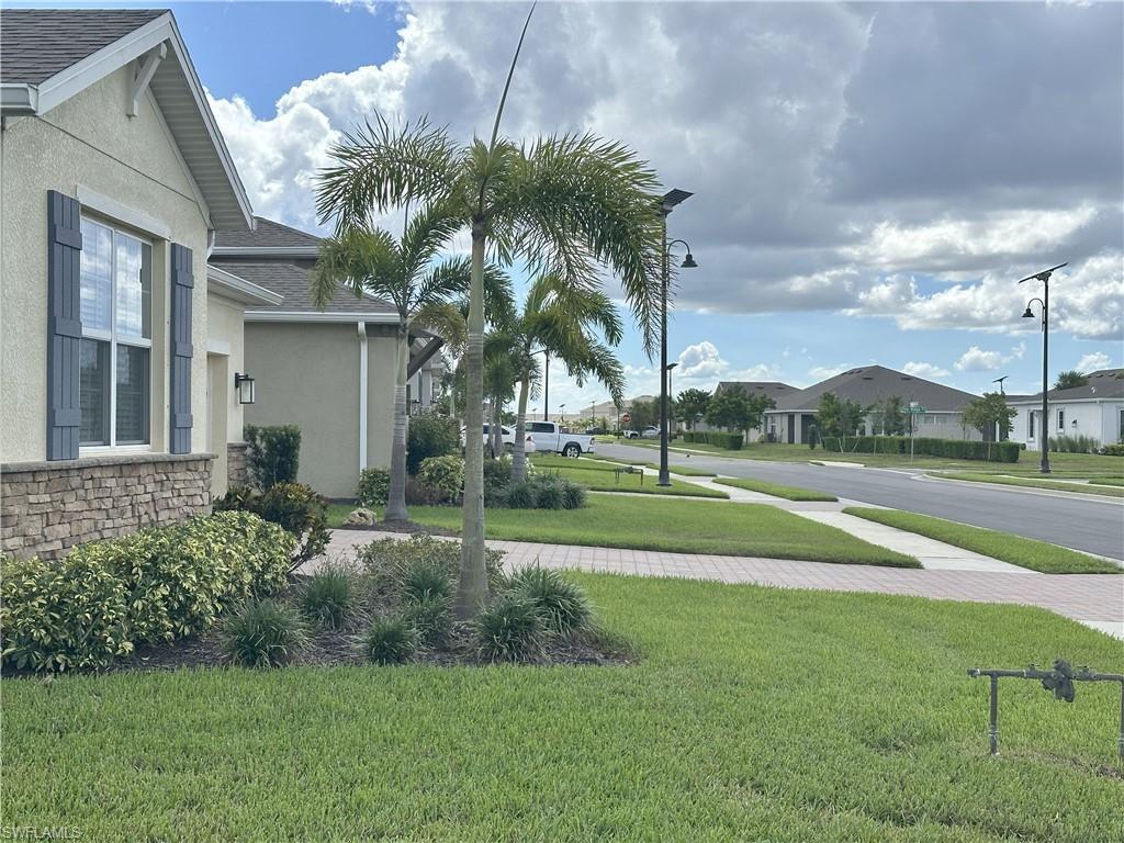 Image 3: View of green lawn with a residential view