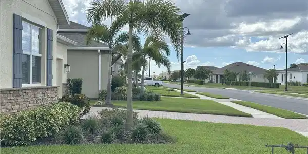Image 3: View of green lawn with a residential view