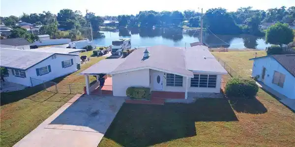 Image 2: Aerial view of property and surrounding area featuring a nearby body of water