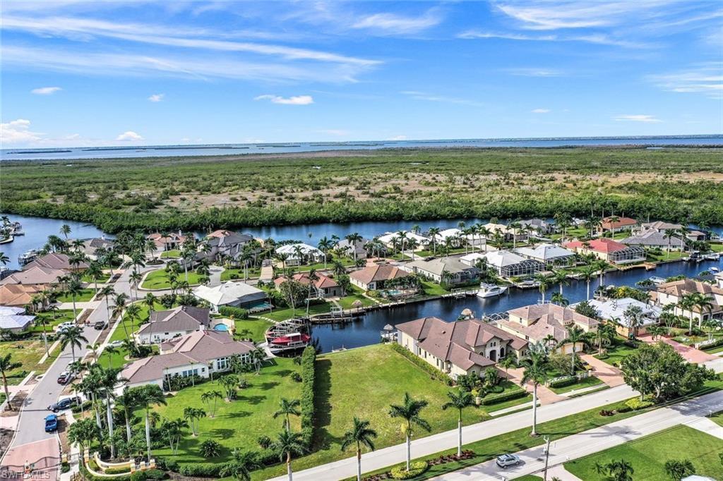 Image 2: Aerial view of residential area with a nearby body of water