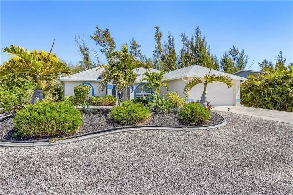 Image 1: Single story home with a garage, driveway, and stucco siding