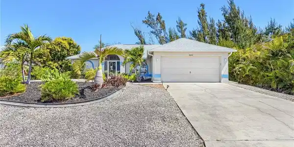 Image 2: Single story home with concrete driveway, an attached garage, and stucco siding