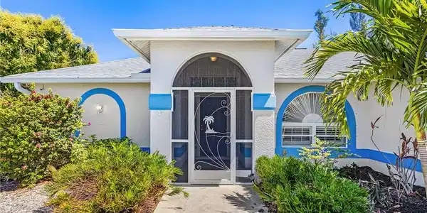 Image 4: Doorway to property with roof with shingles and stucco siding