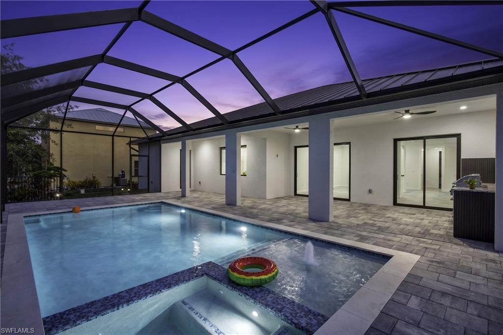 Image 4: SCREENED LANAI w/ PERFECT SETTING TO RELAX in SPA, SWIM in HEATED POOL, or HOST UNFORGETTABLE BBQs!