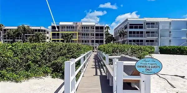 Image 3: A private boardwalk to the beach is located at the rear of Royale Tern