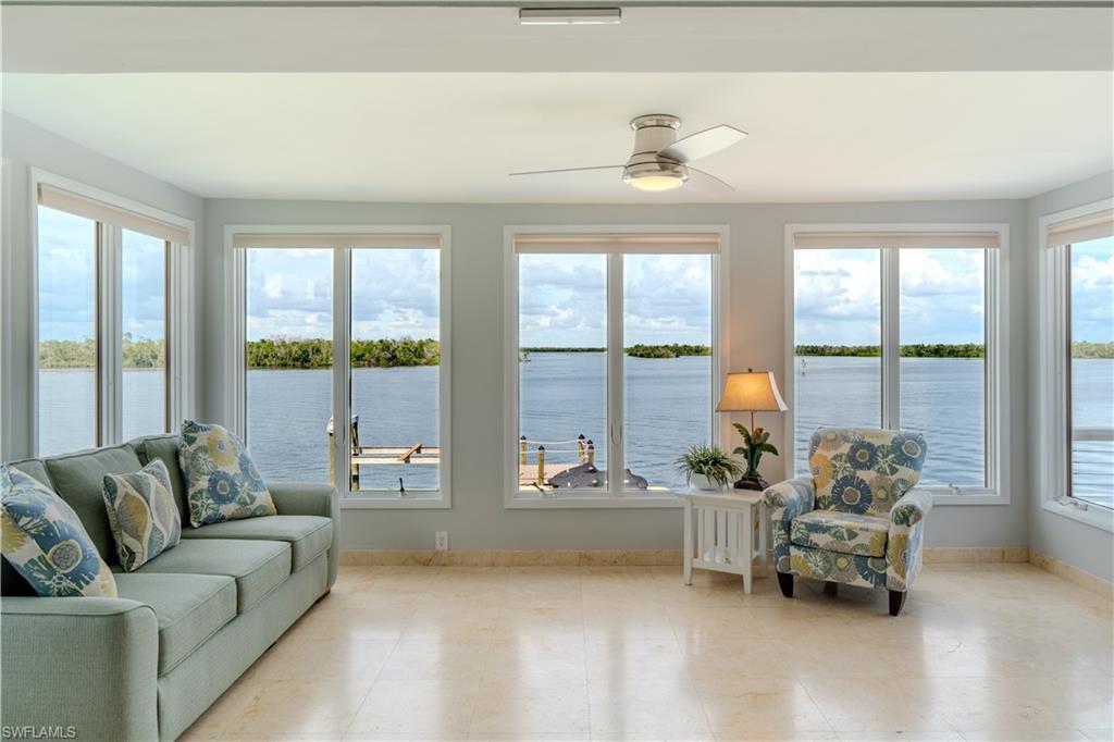 Image 3: Sunroom featuring a water view - Virtually Edited Image