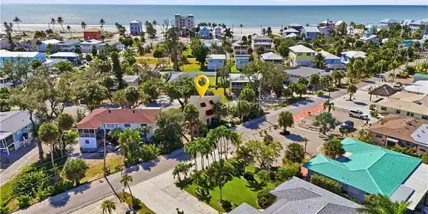 Image 2: Aerial perspective of suburban area featuring a large body of water - Virtually Edited Image