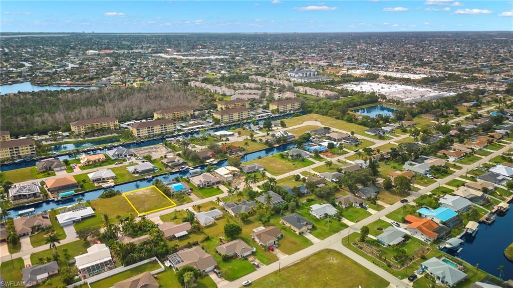 Image 2: View of property location with a nearby body of water and nearby suburban area