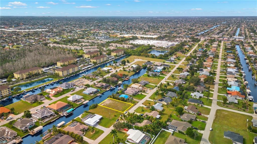 Image 3: Aerial view of property and surrounding area with a nearby body of water and nearby suburban area