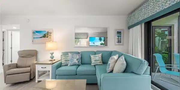 Image 4: Living area featuring wood-finish flooring, a bright paint palette, and crown molding