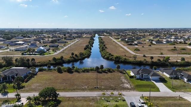 Image 4: Aerial perspective of suburban area featuring a large body of water