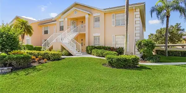 Image 3: View of front of property featuring stucco siding, a front yard, and stairway