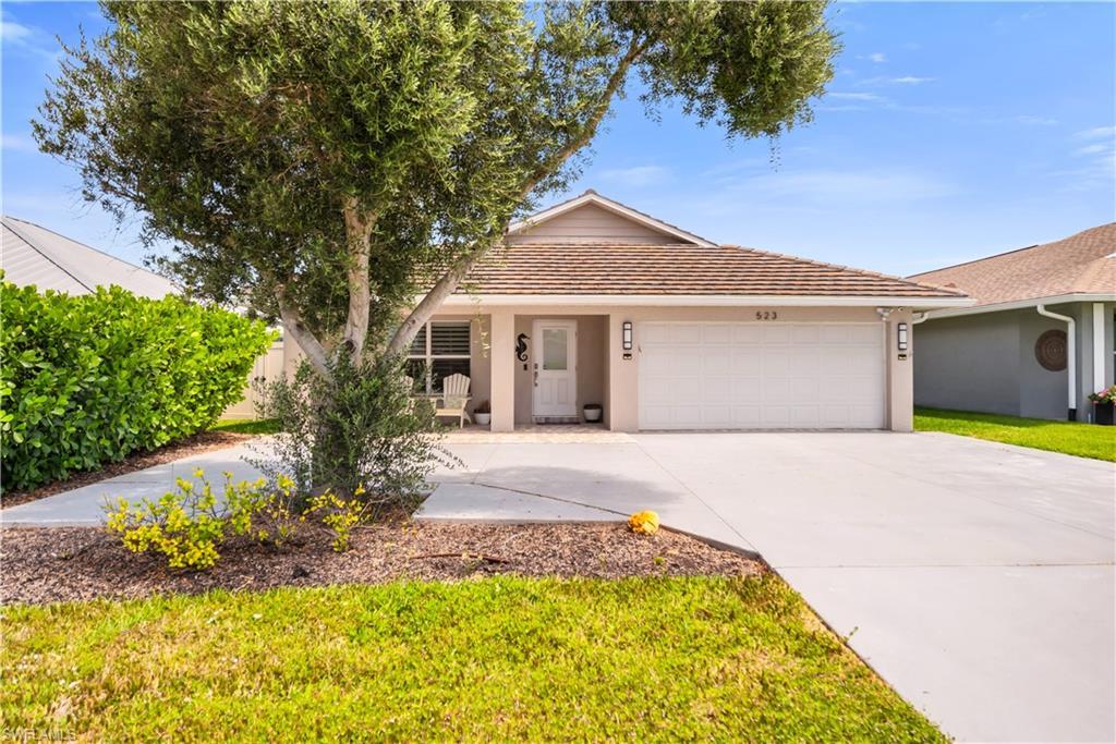 Image 4: Ranch-style house featuring stucco siding, a garage, driveway, and a tile roof