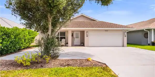 Image 4: Ranch-style house featuring stucco siding, a garage, driveway, and a tile roof