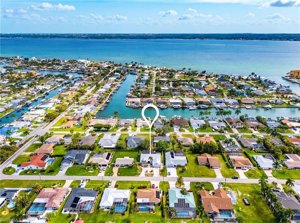 Image 4: Aerial perspective of suburban area with a large body of water