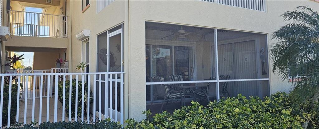 Image 4: View of property exterior featuring stucco siding and a balcony