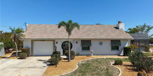 Image 2: Ranch-style home with roof with shingles, a garage, concrete driveway, stucco siding, and a chimney
