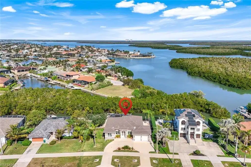 Image 1: Aerial perspective of suburban area with a large body of water