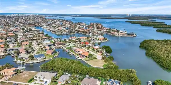Image 2: Aerial view of property and surrounding area featuring nearby suburban area