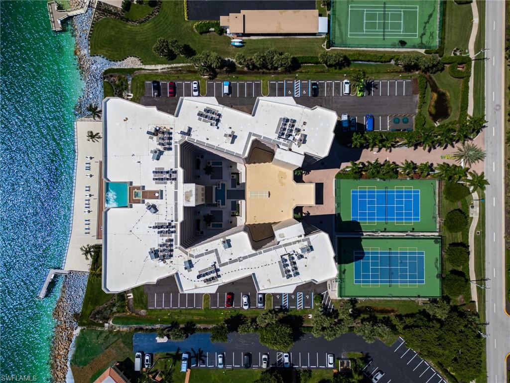Image 4: Bird's eye view of the prestigious Mirage Condominium- highlighting the Gulfside pool and tennis and pickleball activity courts that create this vibrant beachside community.
