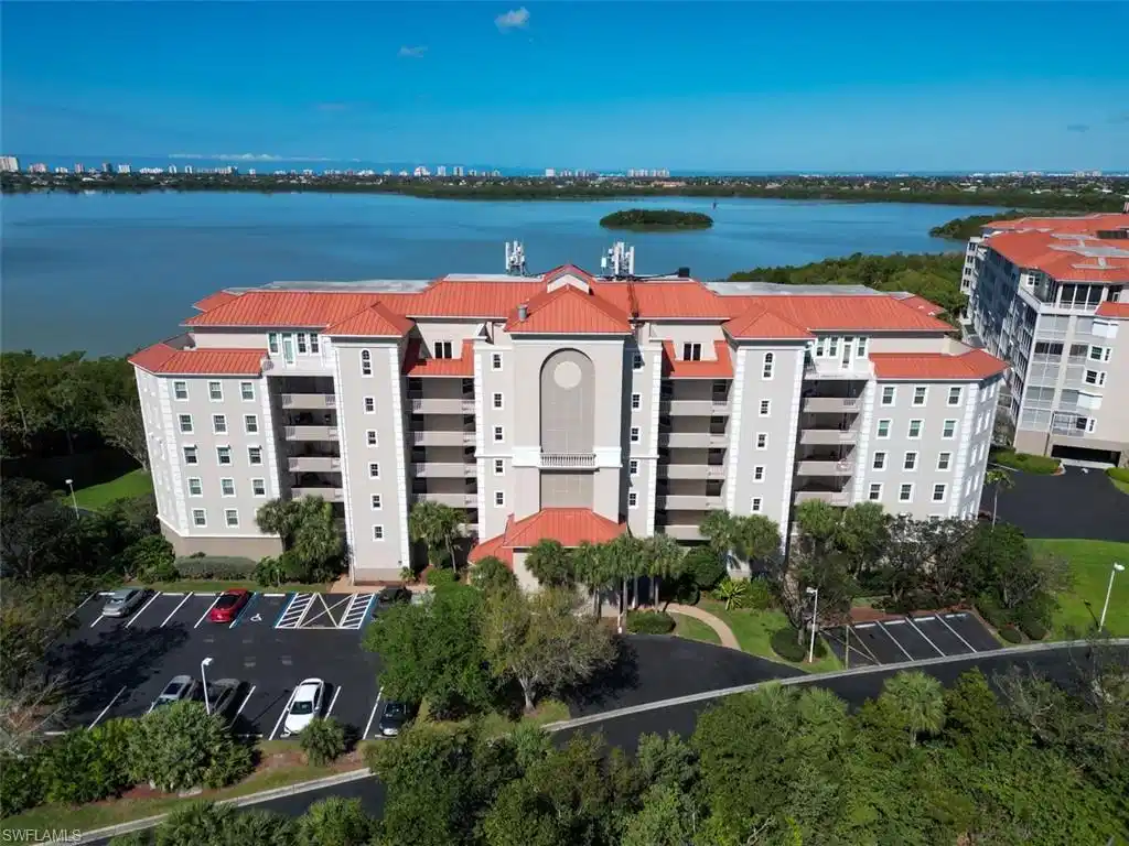 Image 1: Drone / aerial view of apartment complex / building and a large body of water