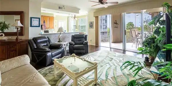 Image 3: Living area featuring a ceiling fan, crown molding, plenty of natural light, a chandelier, and wood finished floors