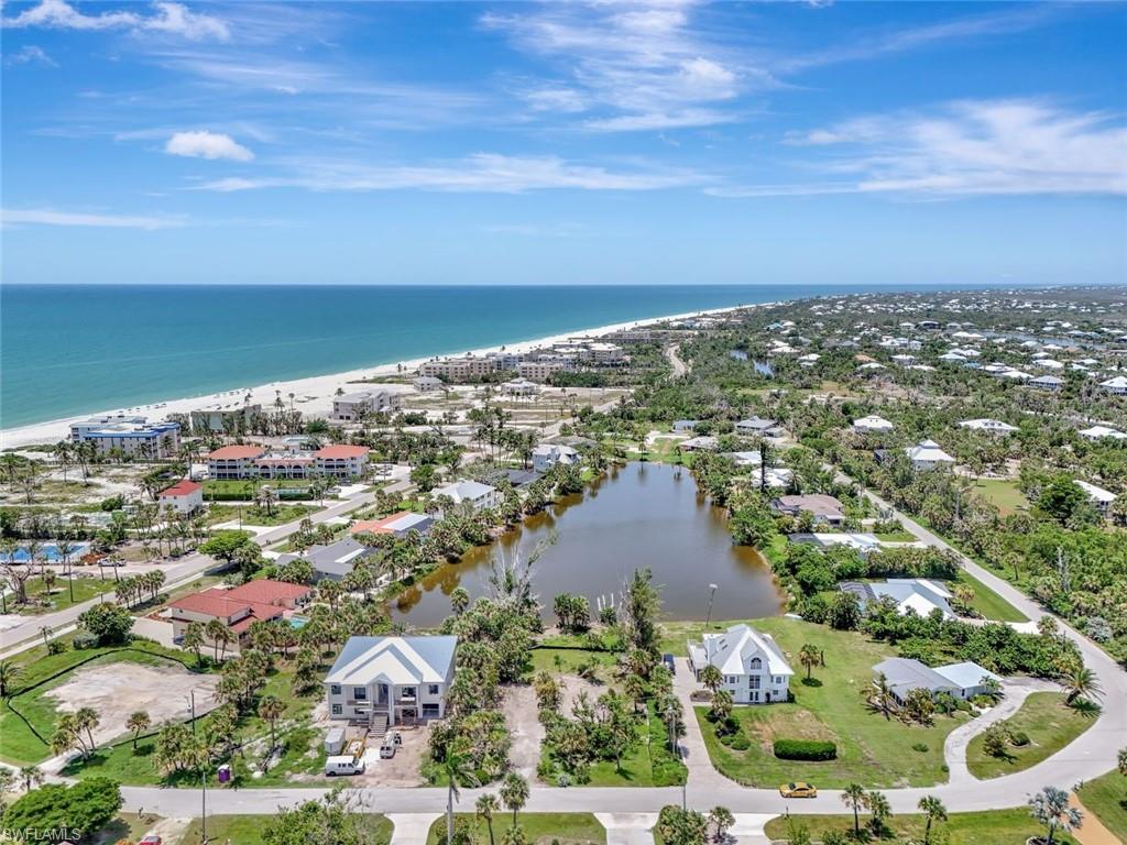 Image 2: Aerial view of residential area featuring expansive beach