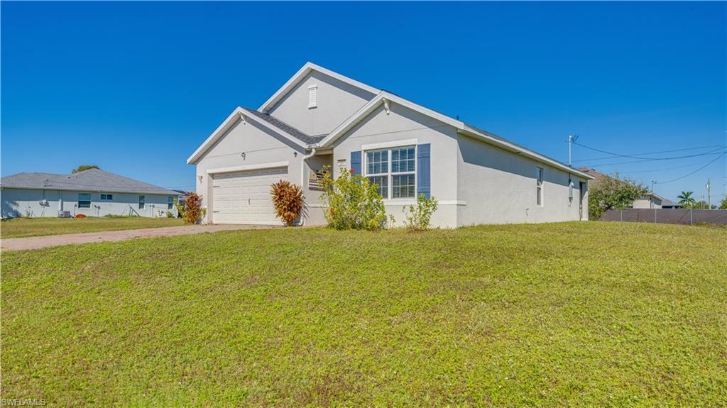 Image 4: Ranch-style house featuring a front lawn, stucco siding, and driveway