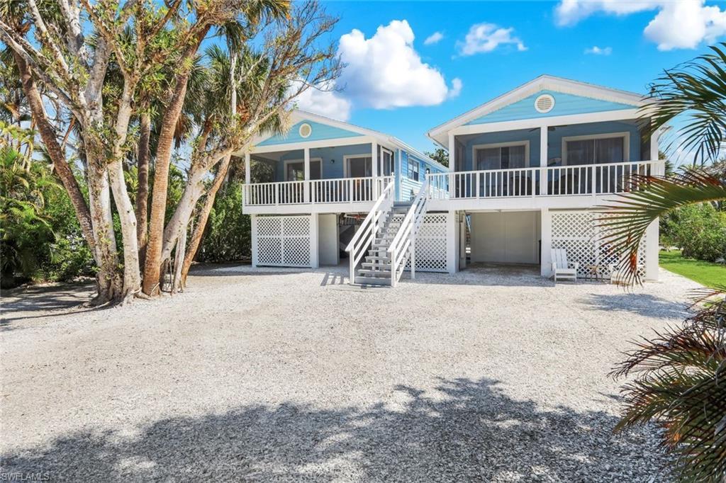 Image 2: View of front of house with gravel driveway, an attached garage, and a sunroom