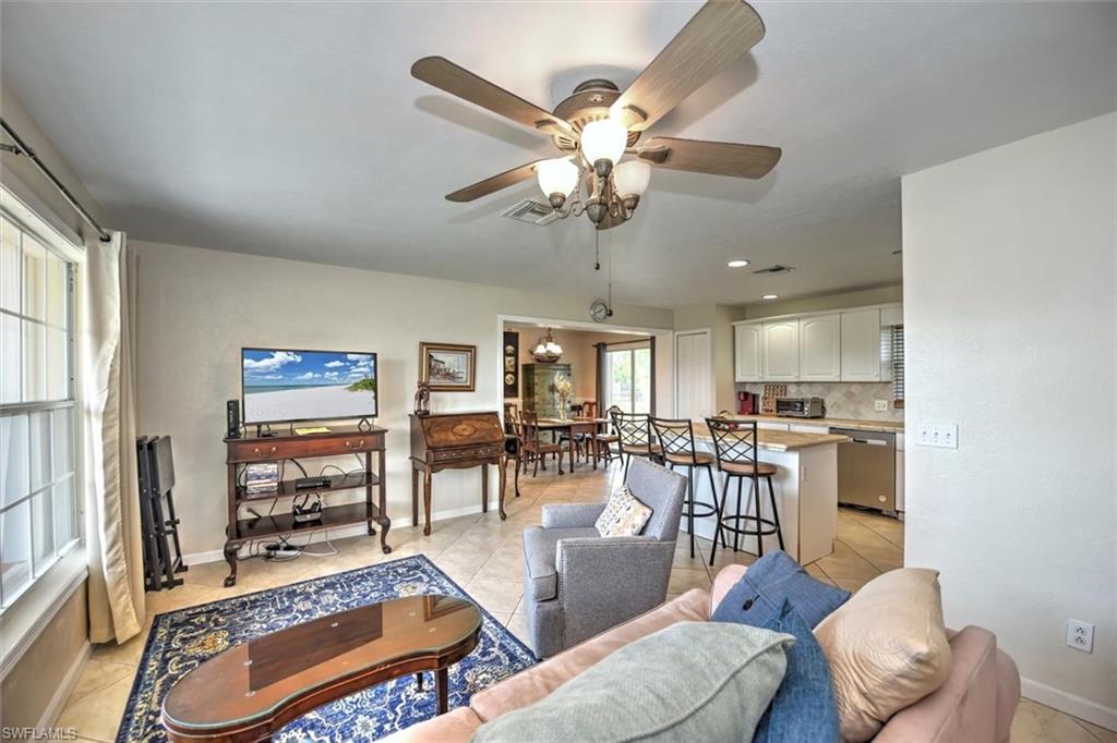 Image 2: Living room featuring visible vents, a ceiling fan, and light tile patterned flooring
