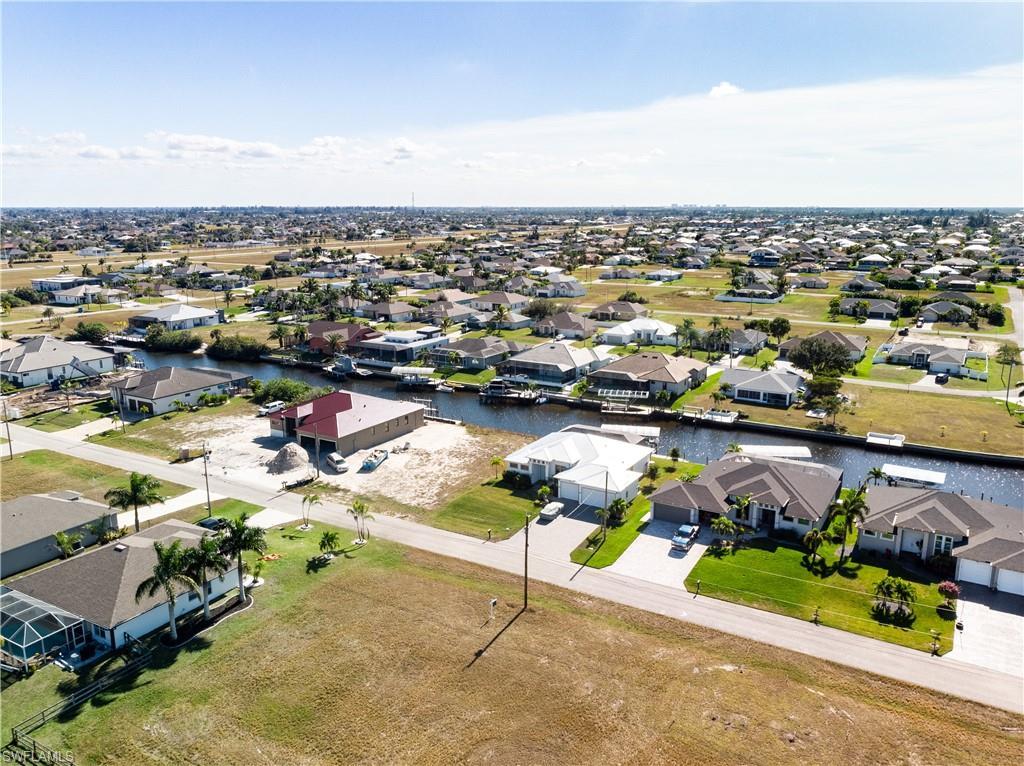 Image 3: Aerial view of residential area with a nearby body of water
