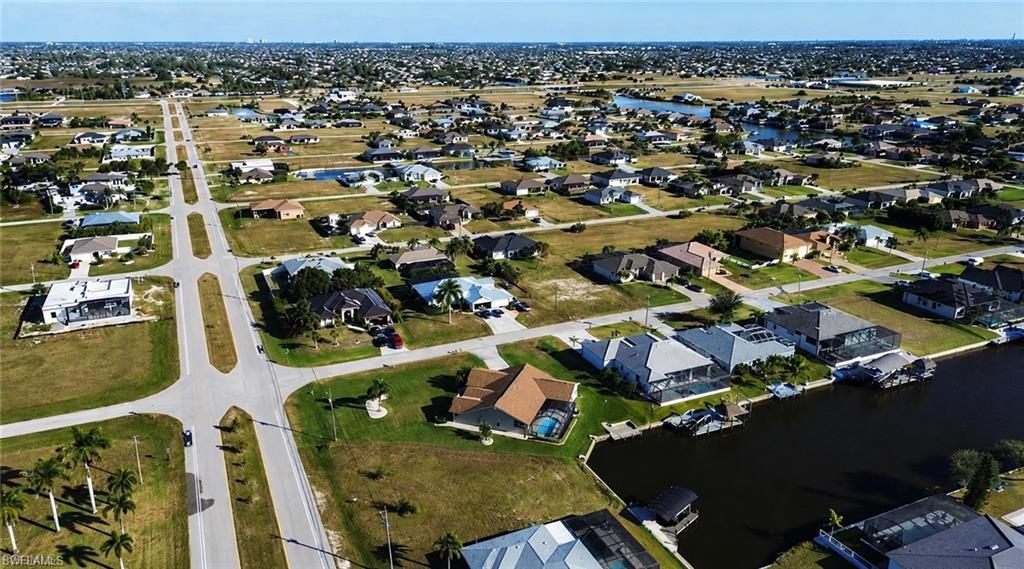 Image 2: Aerial perspective showcasing a residential development with established homes and vacant lots