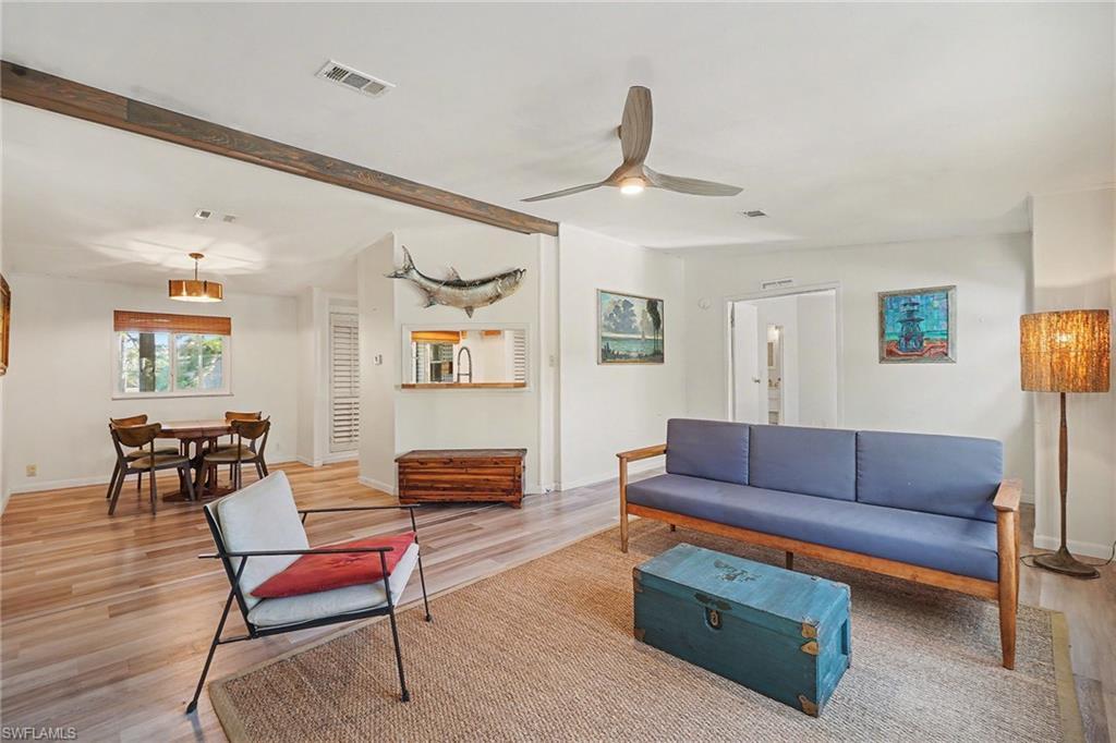 Image 3: Living area with a ceiling fan and light wood-type flooring