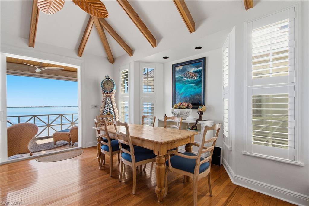 Image 4: Dining area featuring a water view and wood finished floors