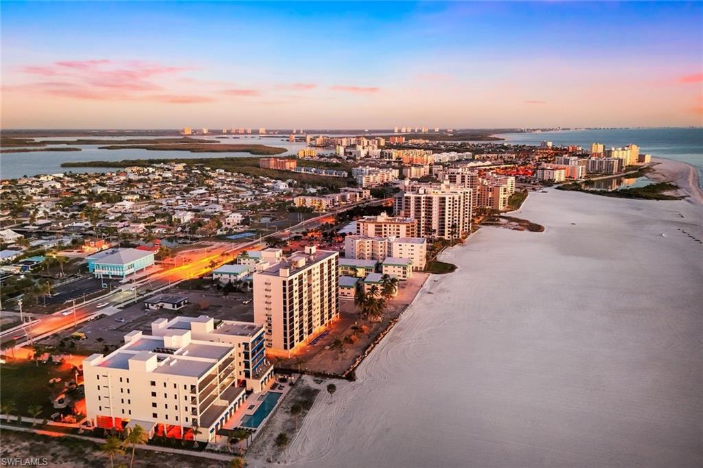 Image 3: Aerial view at dusk of view of water and beach and a city view