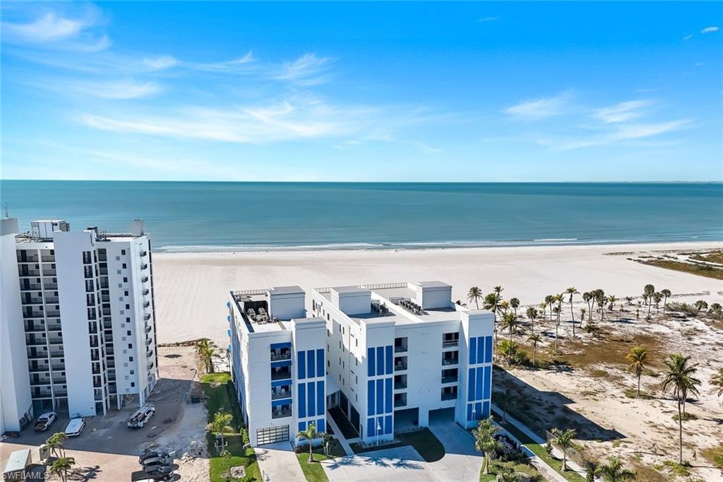 Image 4: Drone / aerial view of expansive beach and apartment complex / building