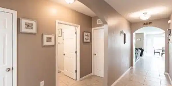 Image 2: Corridor featuring arched walkways and light tile patterned floors