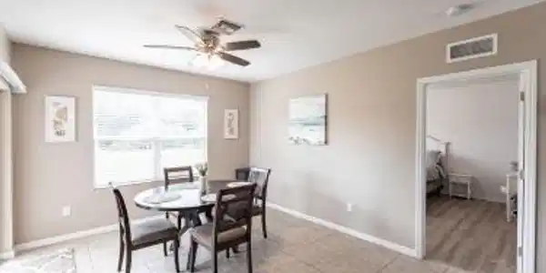 Image 4: Dining room with ceiling fan and light tile patterned floors