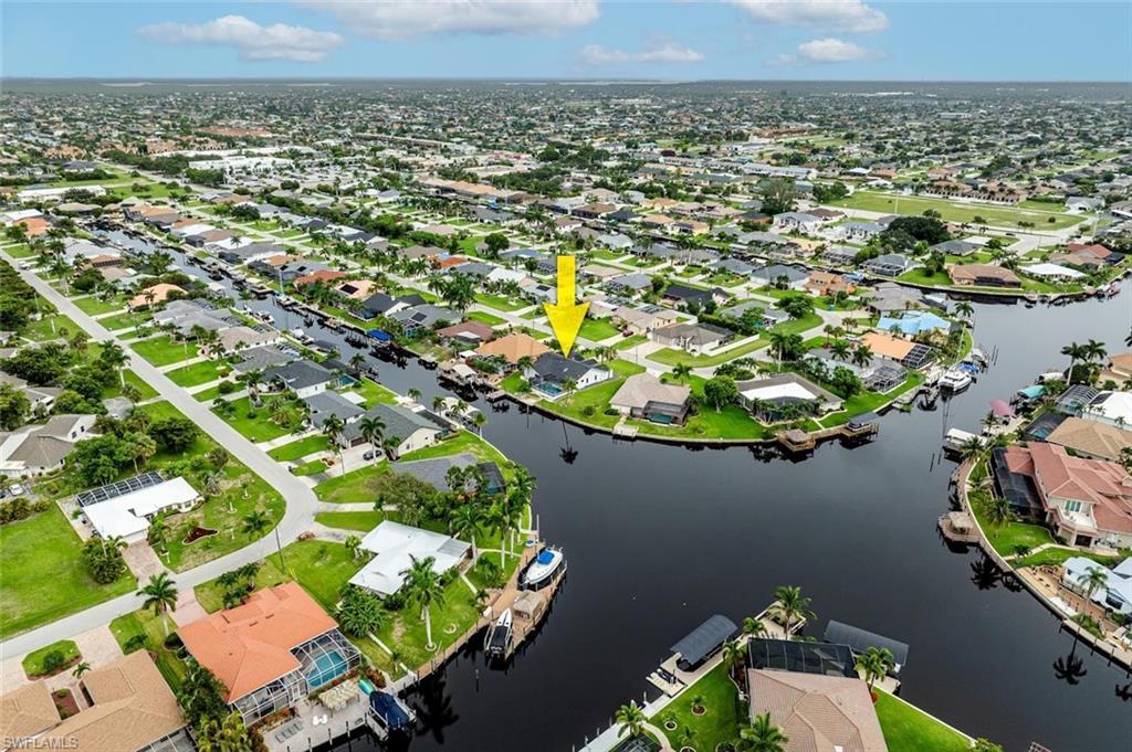 Image 3: Aerial view of property and surrounding area featuring nearby suburban area and a nearby body of water