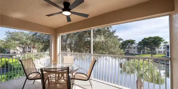 Image 2: Lanai with lake view and water feature.