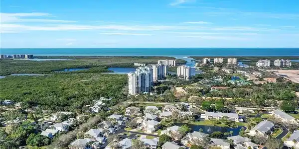 Image 3: View of community facing West. Pristine beaches close by. Pictured is Wiggins Pass State Park (just a 3 mile ride) to the left with gulf access through Wiggins Pass. Barefoot Beach Preserve to the right pictured.