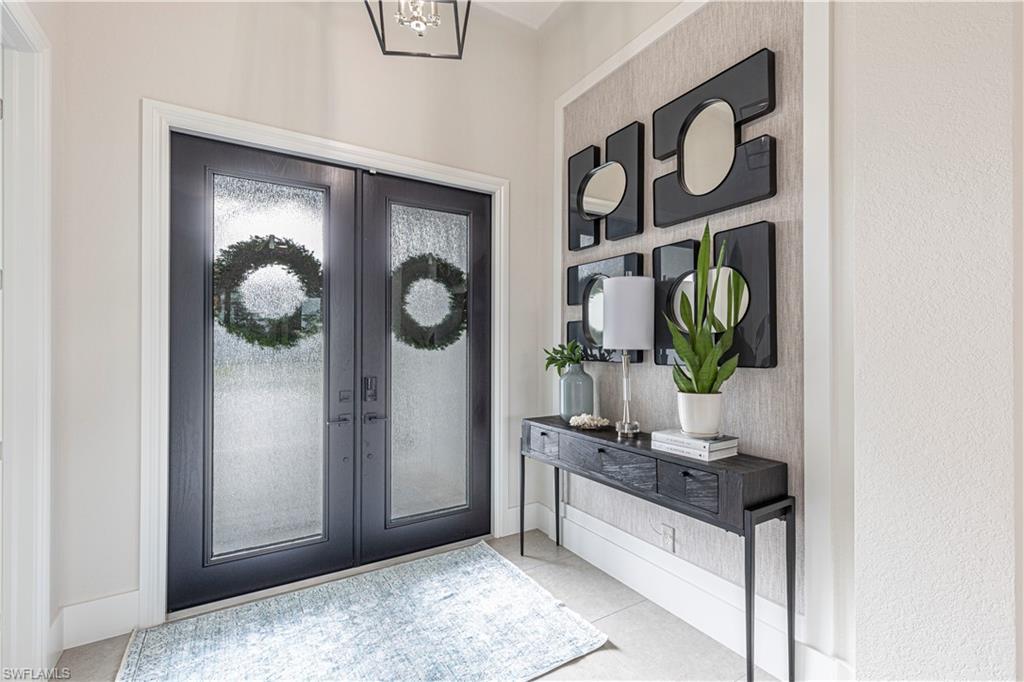 Image 3: Bright Entrance with wall and ceiling custom trim and wall coverings