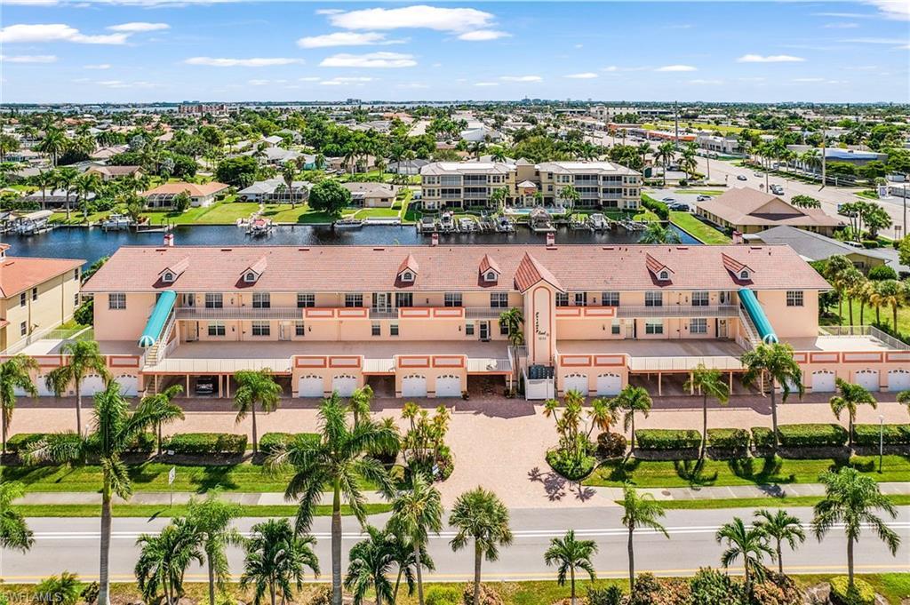 Image 2: Aerial view of residential area featuring a large body of water