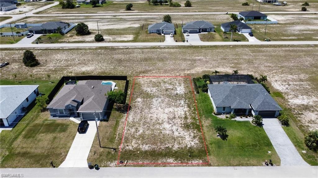 Image 1: Aerial view of residential area with property parcel outlined