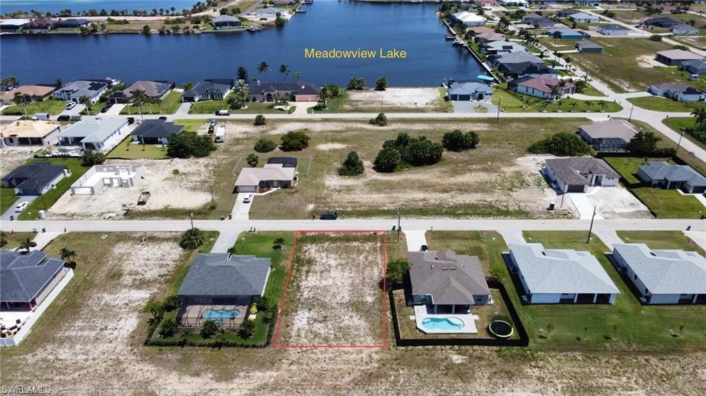 Image 2: Aerial perspective of suburban area with a large body of water