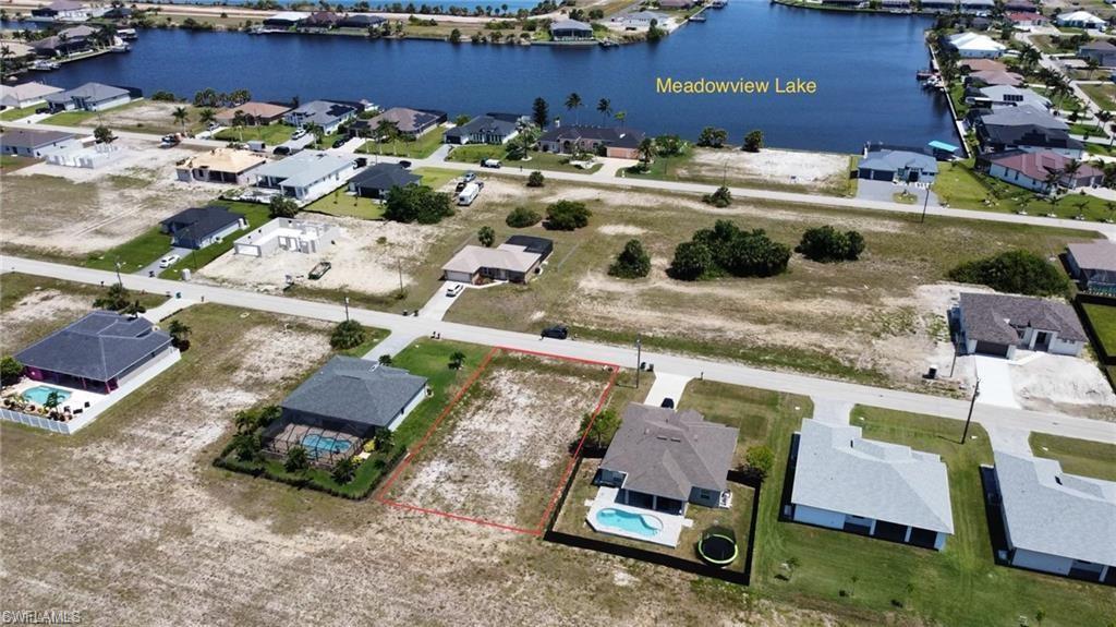 Image 3: Aerial view of residential area with a large body of water